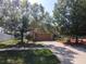 A beautifully landscaped front yard, with mature trees lining the driveway at 3216 White Blossom Ln, Clermont, FL 34711