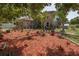 Beautifully landscaped front yard with mulch, lush plants, and well-maintained lawn at 3216 White Blossom Ln, Clermont, FL 34711