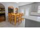 Kitchen connects to dining area with a wooden table and modern gray cabinets and white counters at 3216 White Blossom Ln, Clermont, FL 34711
