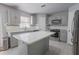 Modern kitchen featuring stainless steel appliances, and gray cabinetry at 3216 White Blossom Ln, Clermont, FL 34711