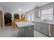 Bright kitchen with white countertops, gray cabinets, and an island, seamlessly connected to dining area at 3216 White Blossom Ln, Clermont, FL 34711