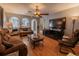 Inviting living room with hardwood floors, ceiling fan, and natural light at 3216 White Blossom Ln, Clermont, FL 34711