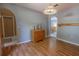 Living room with hardwood floors, vintage cabinet, and arched doorways leading to other areas at 3216 White Blossom Ln, Clermont, FL 34711