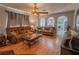 Cozy living room featuring hardwood floors, a ceiling fan, and view of kitchen at 3216 White Blossom Ln, Clermont, FL 34711