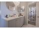 Bright main bathroom featuring double sinks, modern fixtures, and a step-in shower at 3216 White Blossom Ln, Clermont, FL 34711
