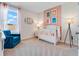 Charming Bedroom with a white crib, soft lighting, and whimsical wall art at 3429 Briarwood Grove, Ocoee, FL 34761