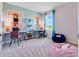 Bright bedroom featuring two desks, comfortable seating, and ample natural light at 3429 Briarwood Grove, Ocoee, FL 34761