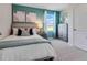 Comfortable bedroom with calming colors, a cozy bed, and natural light from the window at 3429 Briarwood Grove, Ocoee, FL 34761