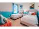 Cozy ' bedroom with two twin beds, playful decor, and plenty of natural light at 3429 Briarwood Grove, Ocoee, FL 34761