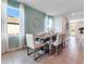 Elegant dining room with a modern table, stylish chairs, and large bright windows at 3429 Briarwood Grove, Ocoee, FL 34761