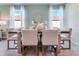 Bright dining room with a modern table setting, contemporary decor, and natural light at 3429 Briarwood Grove, Ocoee, FL 34761