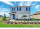 Inviting two-story home featuring a manicured lawn and a welcoming front entrance at 3429 Briarwood Grove, Ocoee, FL 34761