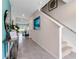 Bright hallway featuring tile flooring and staircase, leading to the main living areas at 3429 Briarwood Grove, Ocoee, FL 34761