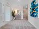 Hallway featuring modern decor, neutral tones, and inviting doorways leading to other rooms at 3429 Briarwood Grove, Ocoee, FL 34761