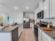 Bright kitchen featuring stainless steel appliances and granite countertops at 3429 Briarwood Grove, Ocoee, FL 34761