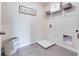 A well-lit laundry room with washer and dryer hookups, and shelving at 3429 Briarwood Grove, Ocoee, FL 34761