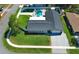 Stunning aerial view of a home with a sparkling pool, lush lawn, and stylish gray roof at 347 Timberwood Trl, Oviedo, FL 32765