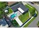 Aerial shot of home showing backyard pool, outdoor living area, and well-manicured lawn at 347 Timberwood Trl, Oviedo, FL 32765
