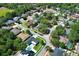 Aerial view showing the home's location in a neighborhood with mature trees and lush landscaping at 347 Timberwood Trl, Oviedo, FL 32765