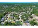 Neighborhood aerial view with mature trees, community streets, and a glimpse of the open water beyond at 347 Timberwood Trl, Oviedo, FL 32765