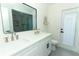 Double sink vanity with bright lighting, modern fixtures, and a glass-enclosed shower at 347 Timberwood Trl, Oviedo, FL 32765