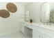 Elegant bathroom features dual sinks, modern fixtures, and decorative wall art at 347 Timberwood Trl, Oviedo, FL 32765