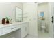 Bright bathroom with a long vanity, dual mirrors, and a toilet in a separate room at 347 Timberwood Trl, Oviedo, FL 32765