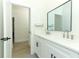 Bright bathroom featuring double sinks, white cabinetry, and sleek black hardware at 347 Timberwood Trl, Oviedo, FL 32765