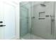 Glass enclosed shower with multiple shower heads and a built-in shower niche at 347 Timberwood Trl, Oviedo, FL 32765