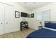 Modern bedroom with a mounted TV, closet, and minimalist decor for a clean look at 347 Timberwood Trl, Oviedo, FL 32765