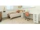 Well-lit bedroom with neutral tones, a stylish rug, and a modern desk setup at 347 Timberwood Trl, Oviedo, FL 32765