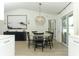 Bright dining room features a modern light fixture and a table with seating for six at 347 Timberwood Trl, Oviedo, FL 32765