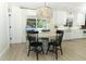 Dining area with chandelier and kitchen access, offering a seamless transition for entertaining at 347 Timberwood Trl, Oviedo, FL 32765