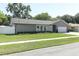 Charming single-story home with a well-manicured lawn and a gray exterior with stone accents at 347 Timberwood Trl, Oviedo, FL 32765