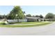 Charming single-story home with a well-manicured lawn, white fence, and beautiful landscaping at 347 Timberwood Trl, Oviedo, FL 32765