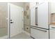 Modern kitchen features a white refrigerator with copper hardware, white cabinets, and designer wall decor at 347 Timberwood Trl, Oviedo, FL 32765