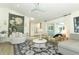 Cozy living room features a comfortable seating area and a view into the modern kitchen at 347 Timberwood Trl, Oviedo, FL 32765
