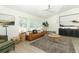 Bright living room featuring neutral decor, a leather sofa, and ample natural light at 347 Timberwood Trl, Oviedo, FL 32765