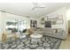 Spacious living room with a large sectional sofa, decorative rug, and access to the backyard at 347 Timberwood Trl, Oviedo, FL 32765
