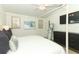 Spacious main bedroom features a four-poster bed, TV, full-length mirror, and stylish dresser at 347 Timberwood Trl, Oviedo, FL 32765