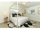 Inviting main bedroom features a four-poster bed, light-filled windows, and stylish decor at 347 Timberwood Trl, Oviedo, FL 32765