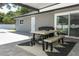 This outdoor patio features an outdoor table, black-and-white rug, and backyard access at 347 Timberwood Trl, Oviedo, FL 32765