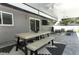 Relax on this covered patio with an outdoor table, ceiling fans, and a mounted television at 347 Timberwood Trl, Oviedo, FL 32765
