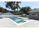 Backyard oasis featuring a sparkling pool, spa, and sun loungers surrounded by lush greenery at 347 Timberwood Trl, Oviedo, FL 32765