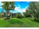 Spacious backyard featuring lush green lawn, mature trees, and a screened patio, ideal for outdoor enjoyment at 3755 Sanibel St, Clermont, FL 34711
