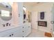 Bathroom featuring dual sinks, white cabinetry, walk-in shower, and a separate toilet area at 3755 Sanibel St, Clermont, FL 34711