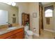 Well-lit bathroom with granite countertop, wood cabinet, and coordinated fixtures offering both style and functionality at 3755 Sanibel St, Clermont, FL 34711