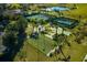Aerial view of bocce ball courts near the tennis courts surrounded by palm trees and greenery at 3755 Sanibel St, Clermont, FL 34711