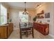 Bright dining area featuring a chandelier, natural light, and built-in cabinetry at 3755 Sanibel St, Clermont, FL 34711