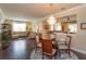 Open concept dining area with a chandelier, hardwood floors and views to the living room and kitchen at 3755 Sanibel St, Clermont, FL 34711